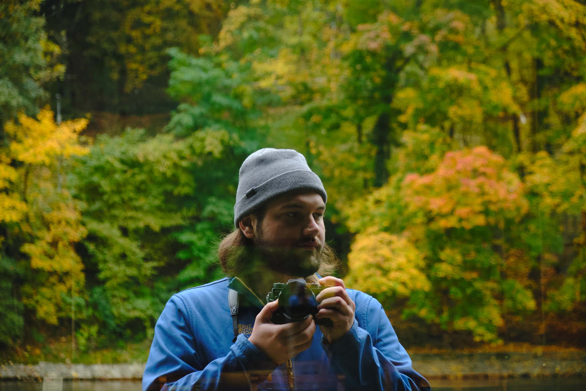 Self-portrait reflected in autumn glass